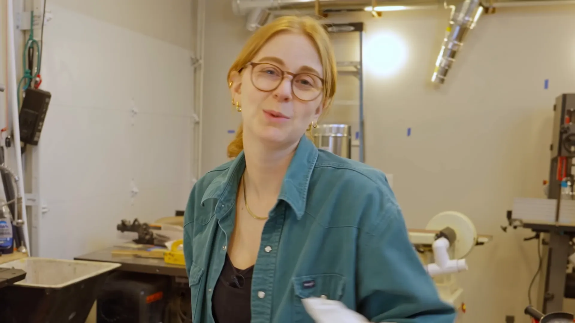 Simone Giertz in her workshop, wearing glasses